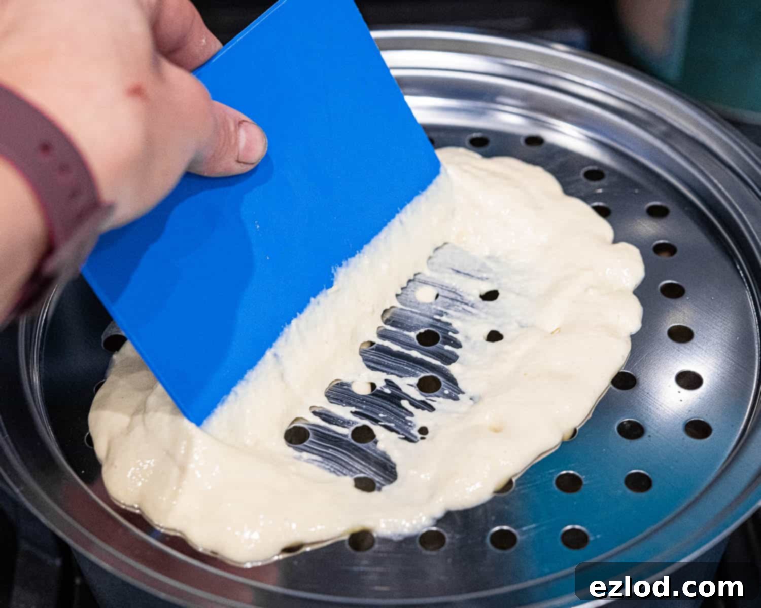 Step 3, scraping the batter into the water.