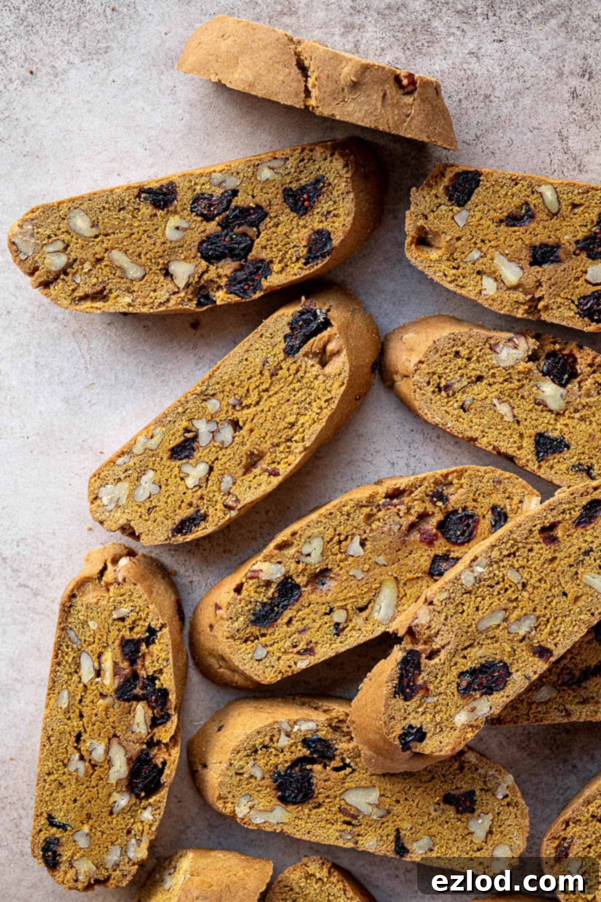 A perfectly baked vegan pumpkin biscotti resting on a rustic brown surface, ready for enjoyment.