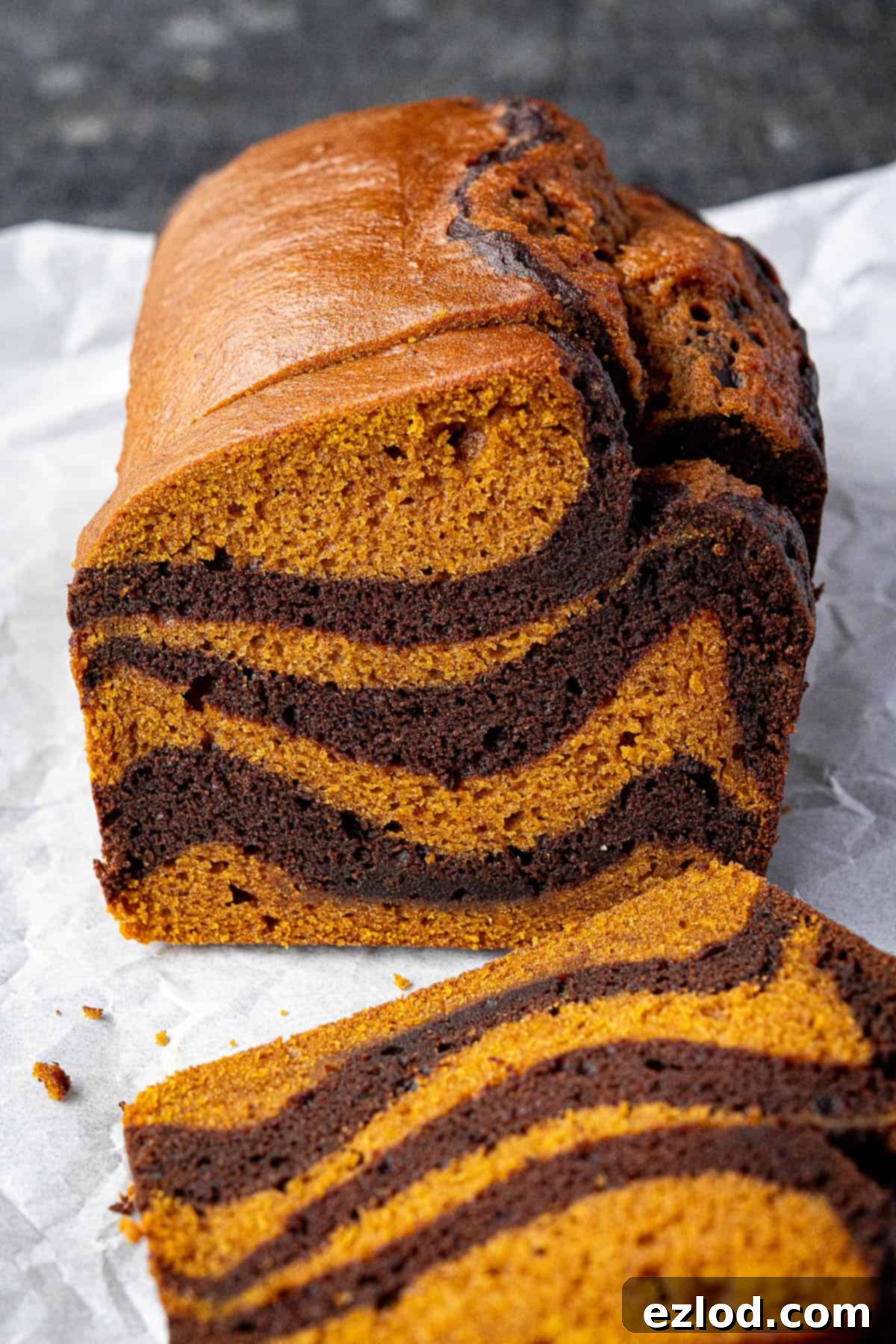 A close-up shot of individual slices of pumpkin chocolate marble bread, highlighting the beautiful marbling and moist texture.