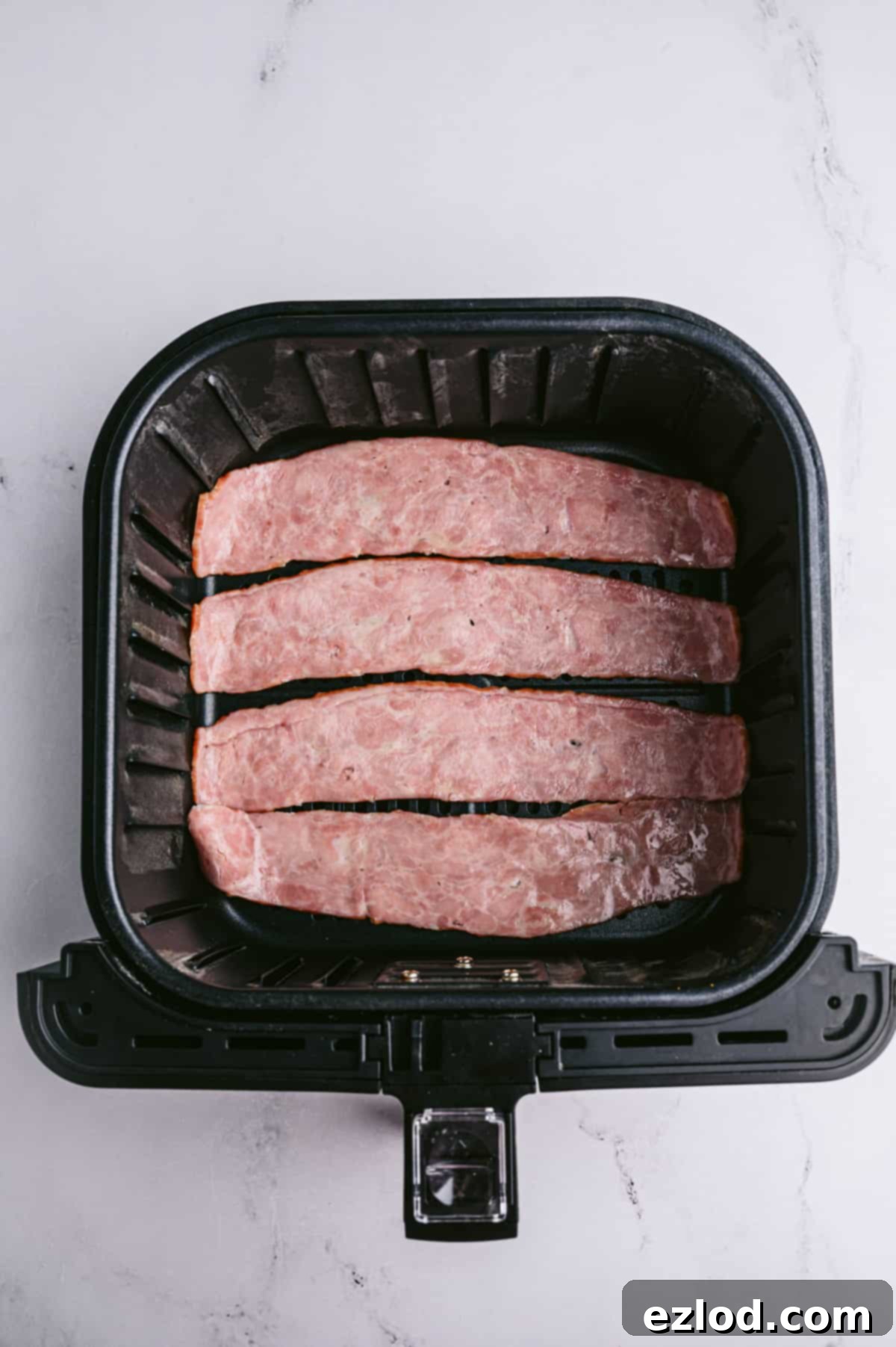 Crispy Air Fryer Turkey Bacon 4 Four strips of turkey bacon in an air fryer