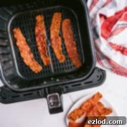 Crispy Air Fryer Turkey Bacon 8 Crispy Air Fryer Turkey Bacon slices on a plate.