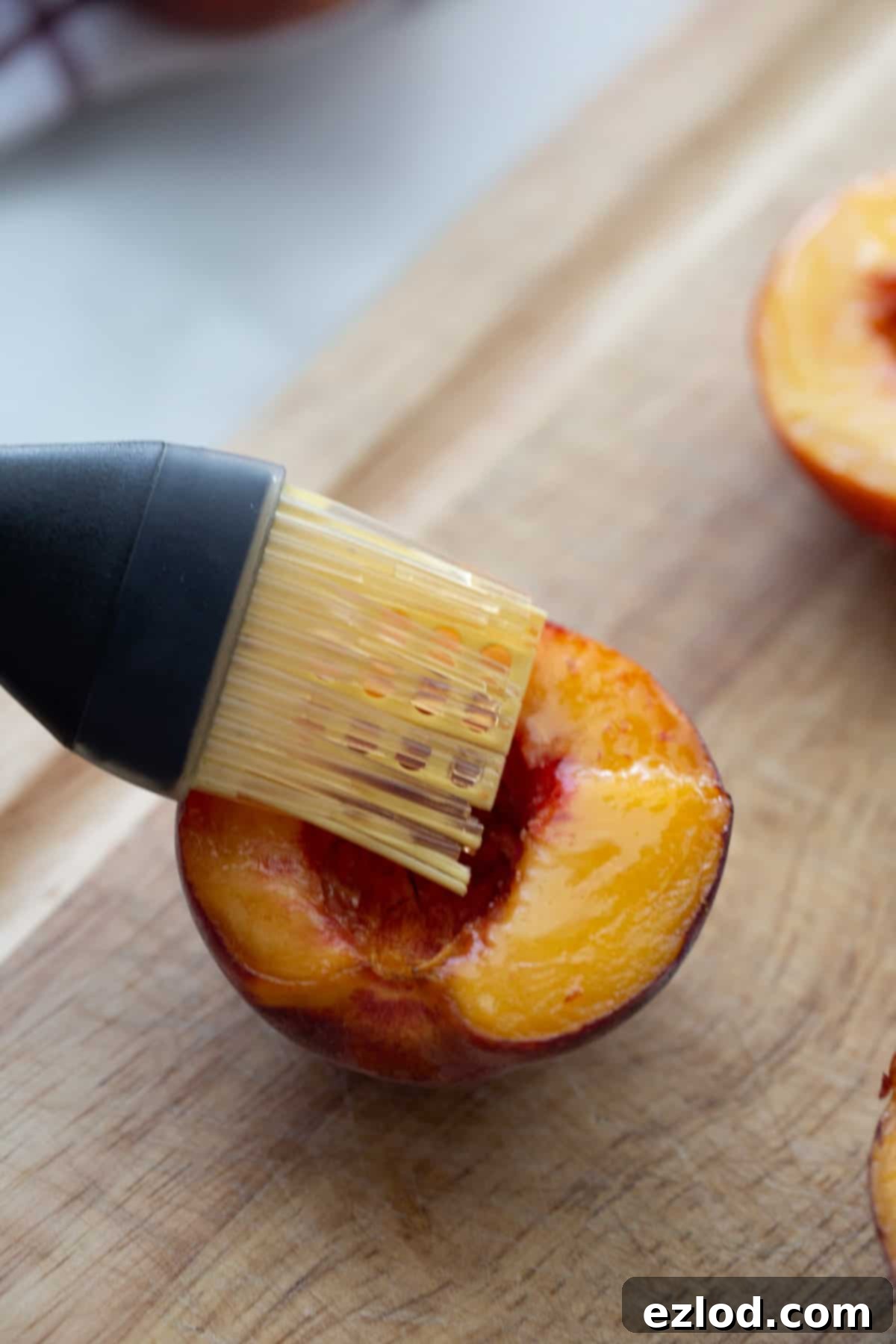 Sweet Air Fried Peaches with Creamy Ricotta 6 Half of a peach with coconut oil being brushed on top