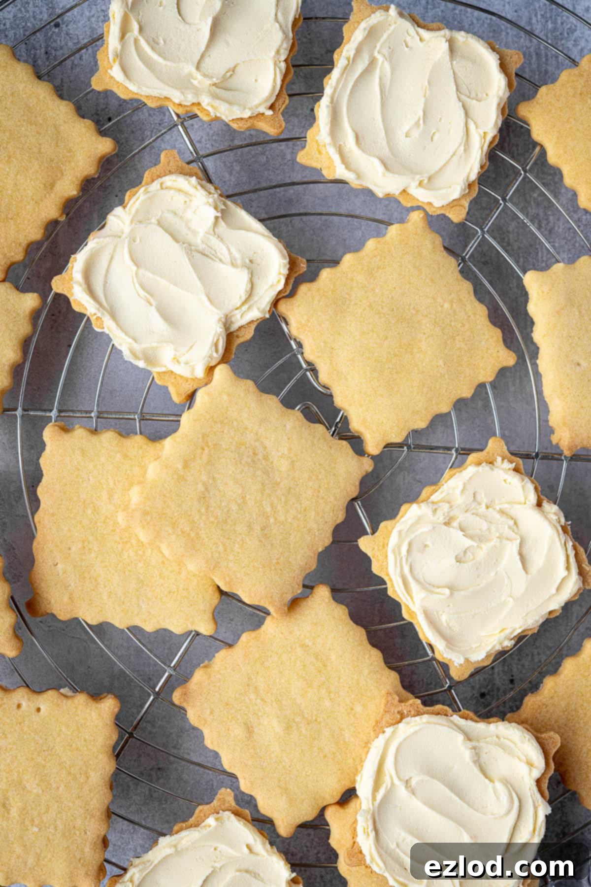 A close-up shot of several vegan custard creams, showcasing their intricate pattern and creamy filling, arranged invitingly on a wire cooling rack.
