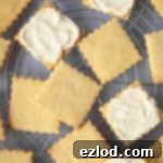 Close up of vegan custard creams on a wire cooling rack.