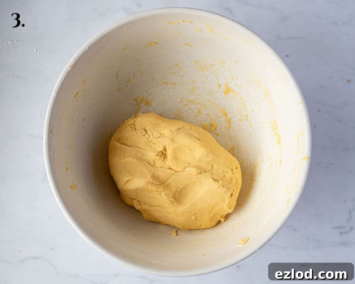 Step 3 in making vegan custard creams: the finished, smooth, and pliable biscuit dough in a mixing bowl, ready for chilling or rolling.