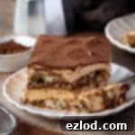 A slice of vegan pumpkin tiramisu on a plate with a fork.