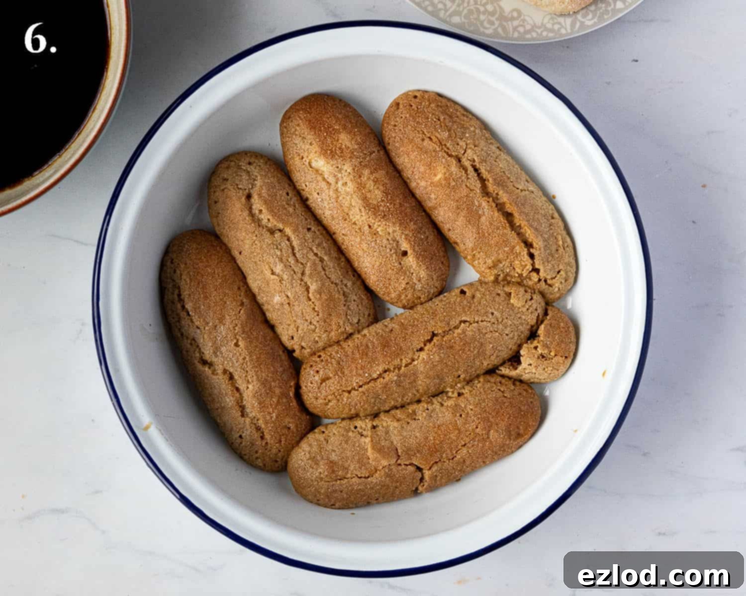 Step 6, the first layer of ladyfingers in the dish.