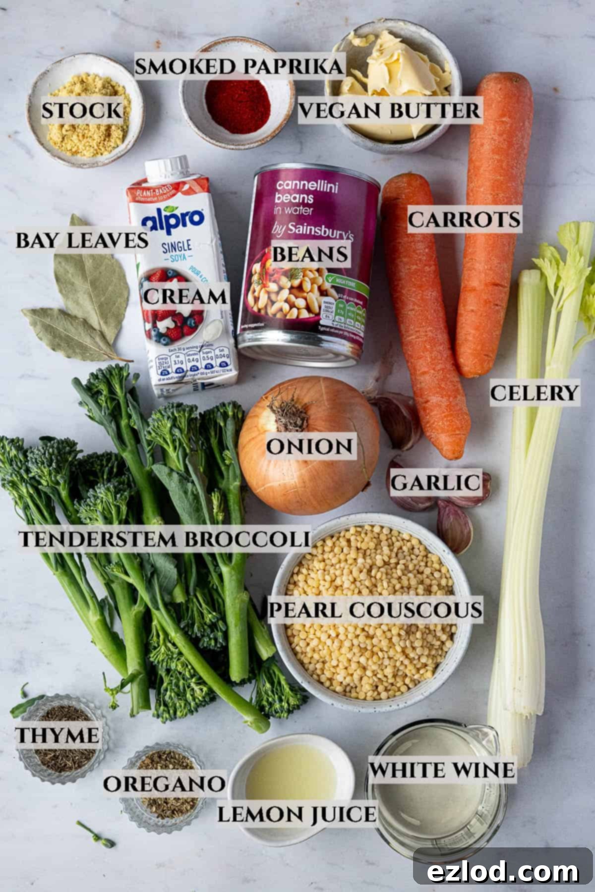 Velvety Vegan Pearl Couscous Soup 3 A labelled photo of the ingredients needed to make creamy pearl couscous soup, laid out neatly on a wooden surface.