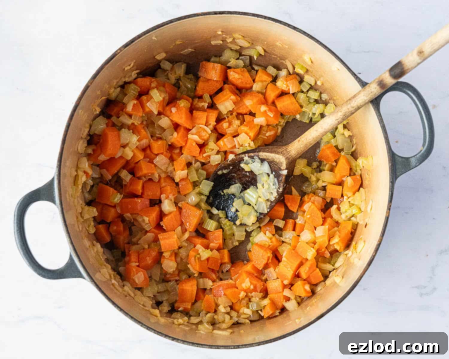 Velvety Vegan Pearl Couscous Soup 5 Step 1 in making creamy pearl couscous soup: the cooked, softened vegetables (onion, garlic, celery, carrot) gently sautéing in a pan.