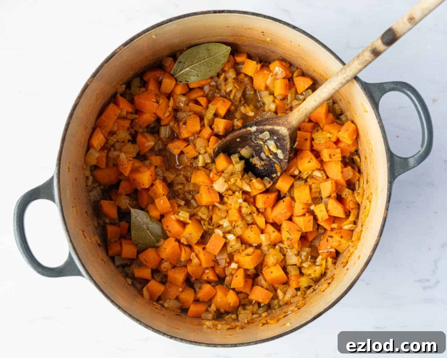Velvety Vegan Pearl Couscous Soup 6 Step 2 in making creamy pearl couscous soup: vegetables with added herbs and white wine, simmering until the liquid evaporates.