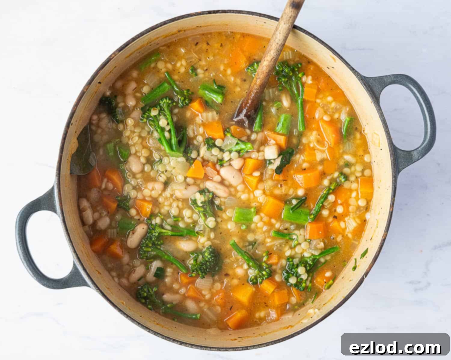 Velvety Vegan Pearl Couscous Soup 8 Step 4 in making creamy pearl couscous soup: broccoli and cannellini beans added to the simmering soup.