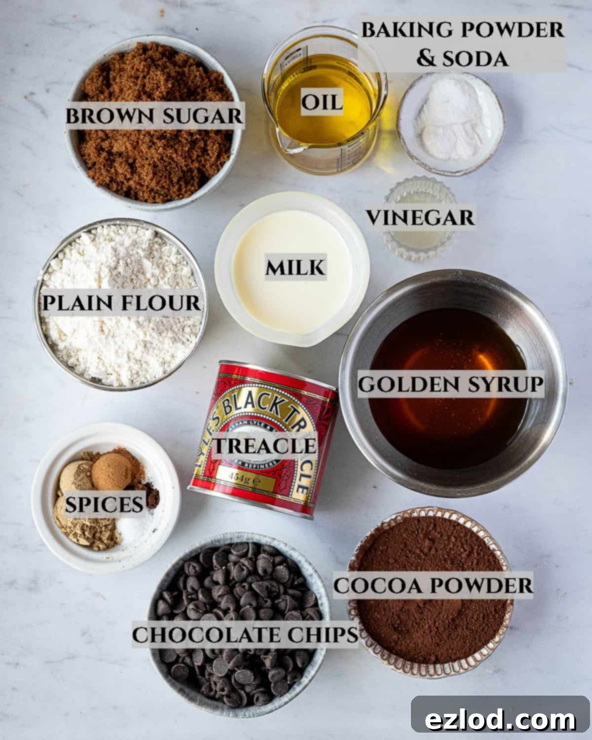 Decadent Vegan Chocolate Gingerbread Cake 3 A labelled photo showing all the individual ingredients for vegan chocolate gingerbread in small bowls, ready for baking.