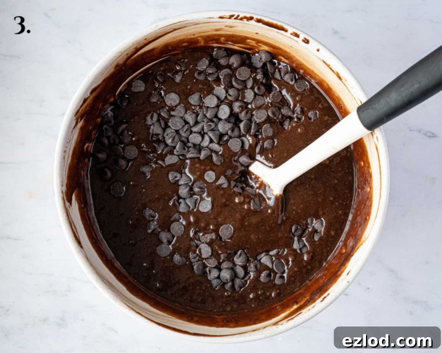 Decadent Vegan Chocolate Gingerbread Cake 7 Step 3: Chocolate chips being gently folded into the rich chocolate gingerbread batter.