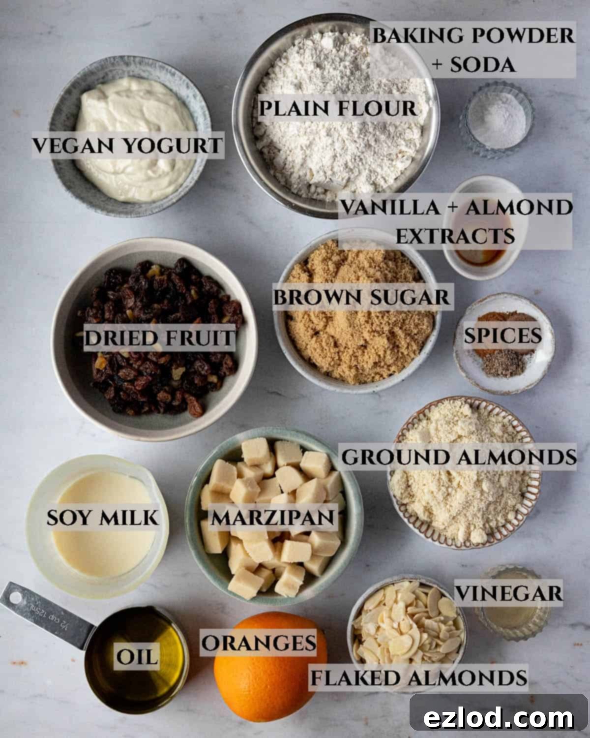 Festive Vegan Stollen Muffins 3 A labelled photo displaying all the essential ingredients laid out for making vegan stollen muffins, highlighting their freshness and variety.