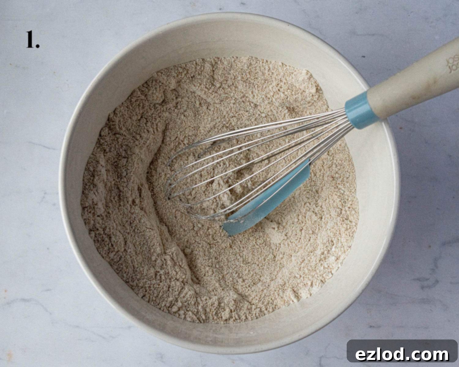 Festive Vegan Stollen Muffins 5 Step 1: The carefully measured dry ingredients for stollen muffins are whisked together in a bowl.