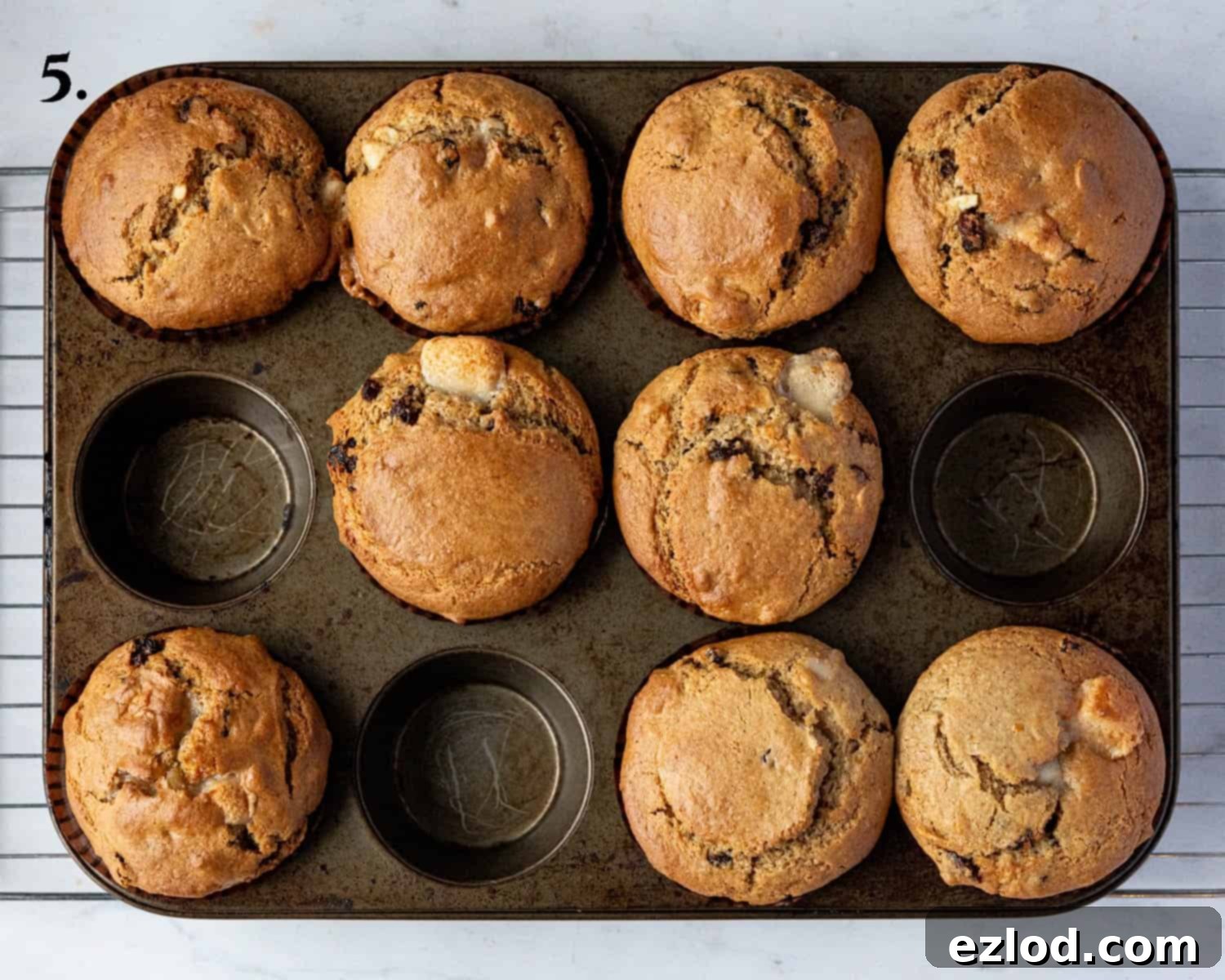 Festive Vegan Stollen Muffins 9 Step 5: The freshly baked vegan stollen muffins, golden brown and perfectly risen, resting in their tin.