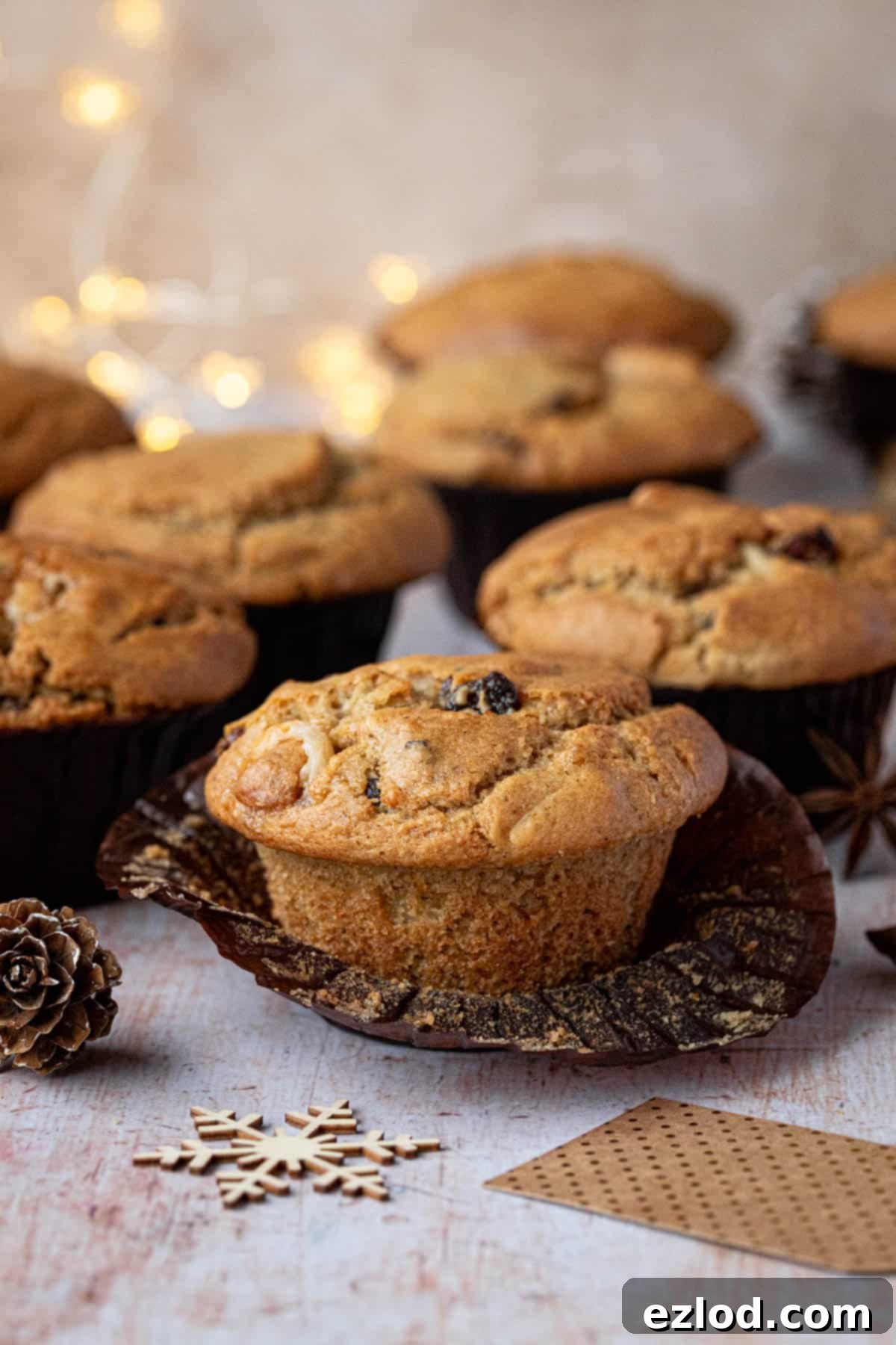 Festive Vegan Stollen Muffins 10 A close-up shot of a single vegan stollen muffin with its paper case carefully removed, revealing its tender crumb and festive inclusions.