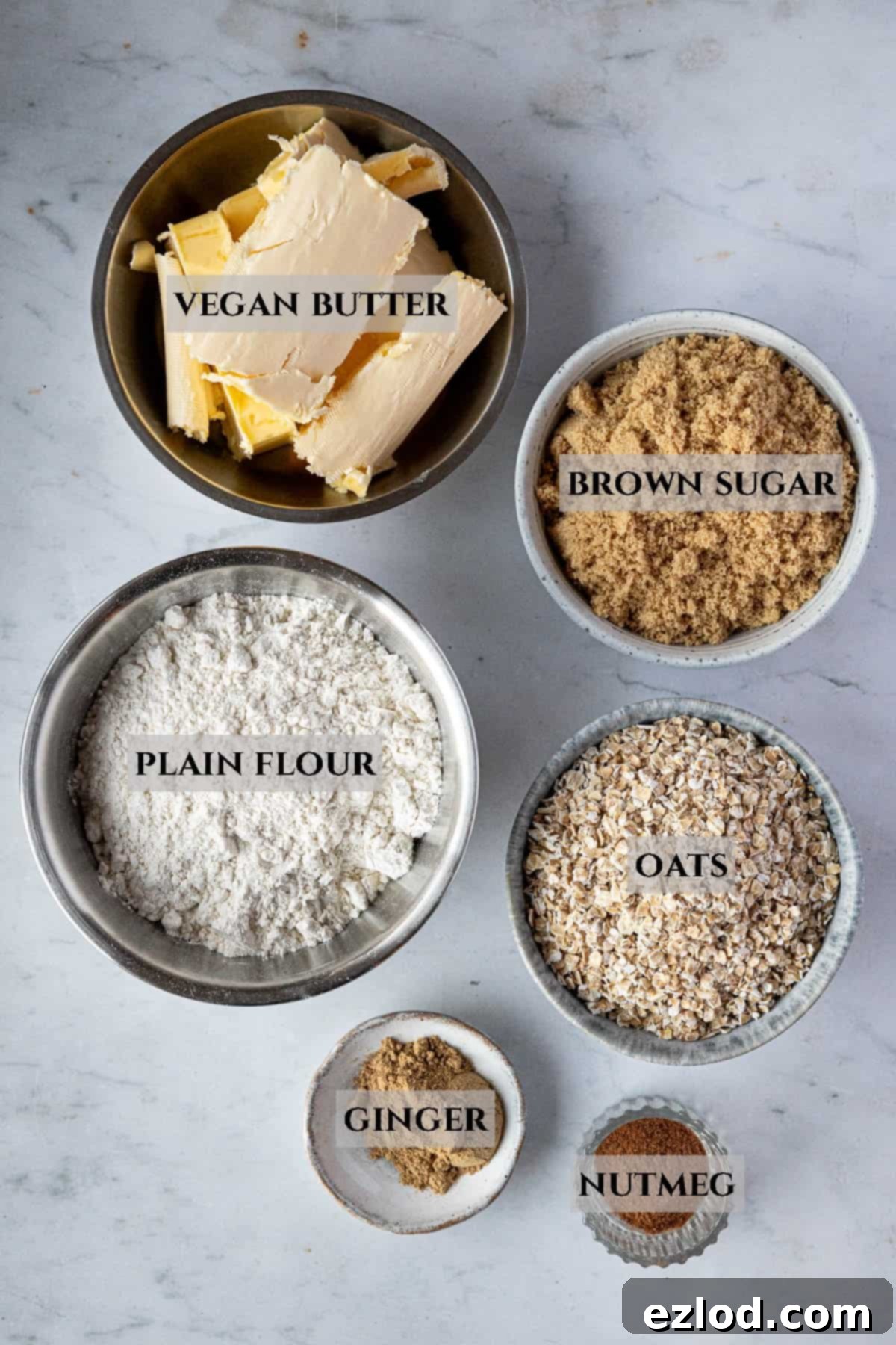 A labelled image of the ingredients needed to make spiced oat biscuits.