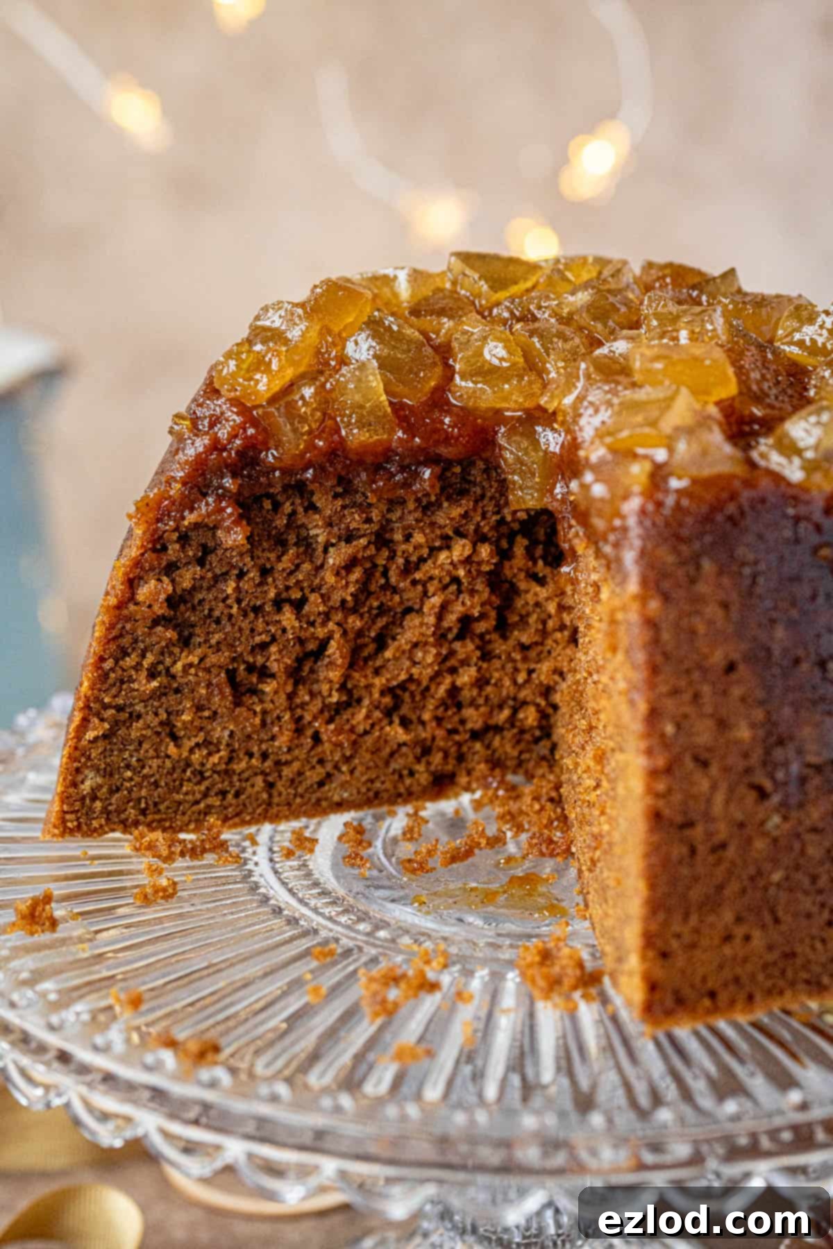 Close up of a slice of steamed vegan gingerbread pudding with a sticky ginger topping.