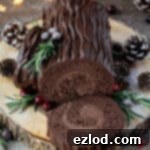 Plant-Based Chocolate Yule Log 17 A festive vegan chocolate yule log on a wooden board with cozy pine cones and twinkling fairy lights, ready to be served.