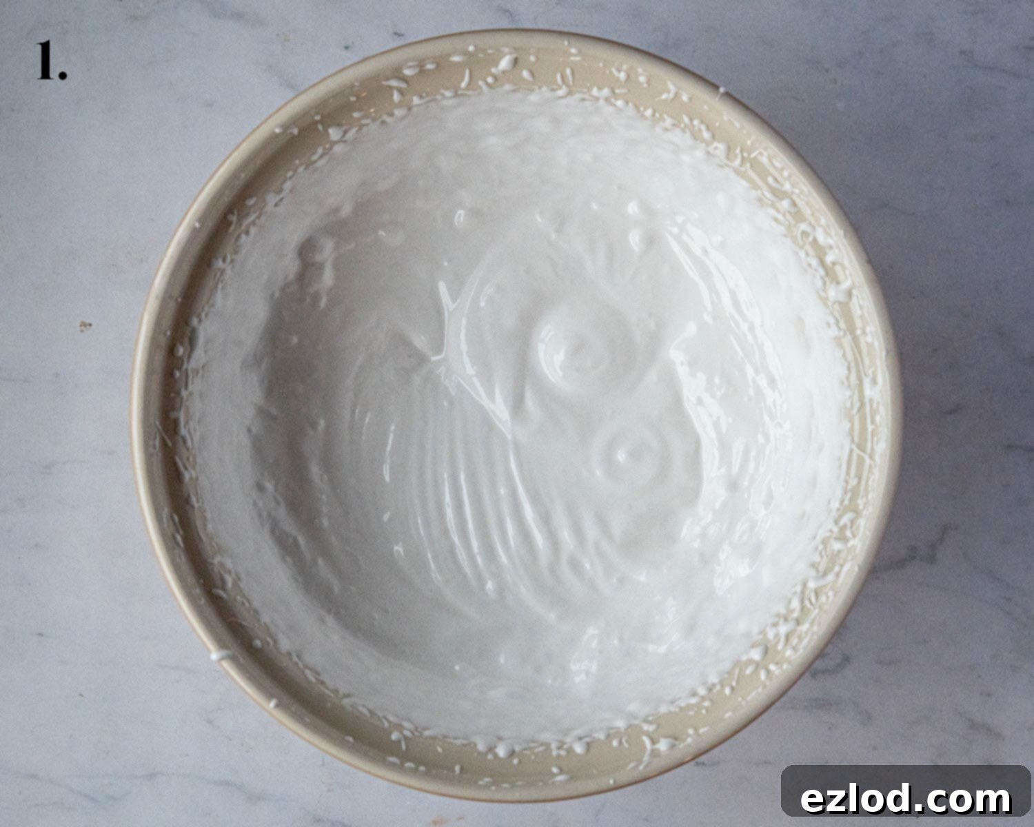 Plant-Based Chocolate Yule Log 5 Step 1: The whisked aquafaba, showing a light, frothy, and glossy consistency, ready for the next ingredients.