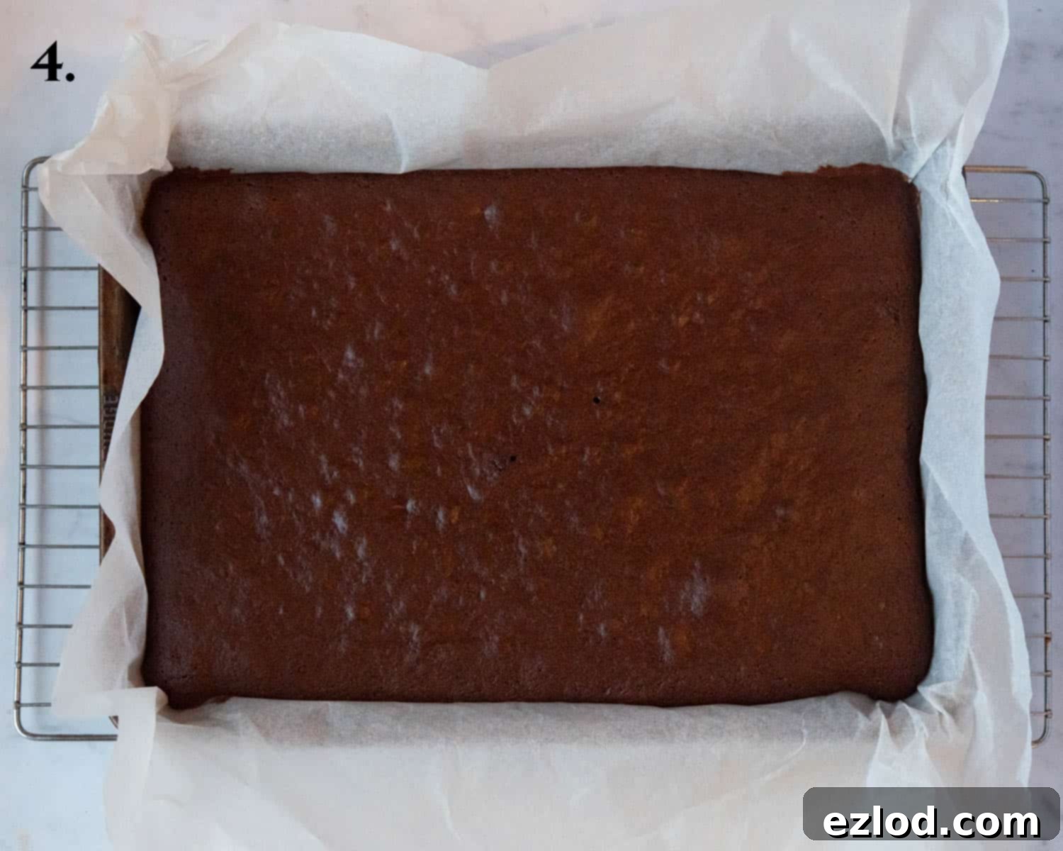 Plant-Based Chocolate Yule Log 8 Step 4: The freshly baked cake, golden brown and perfectly risen, cooling in the Swiss roll tin after being removed from the oven.