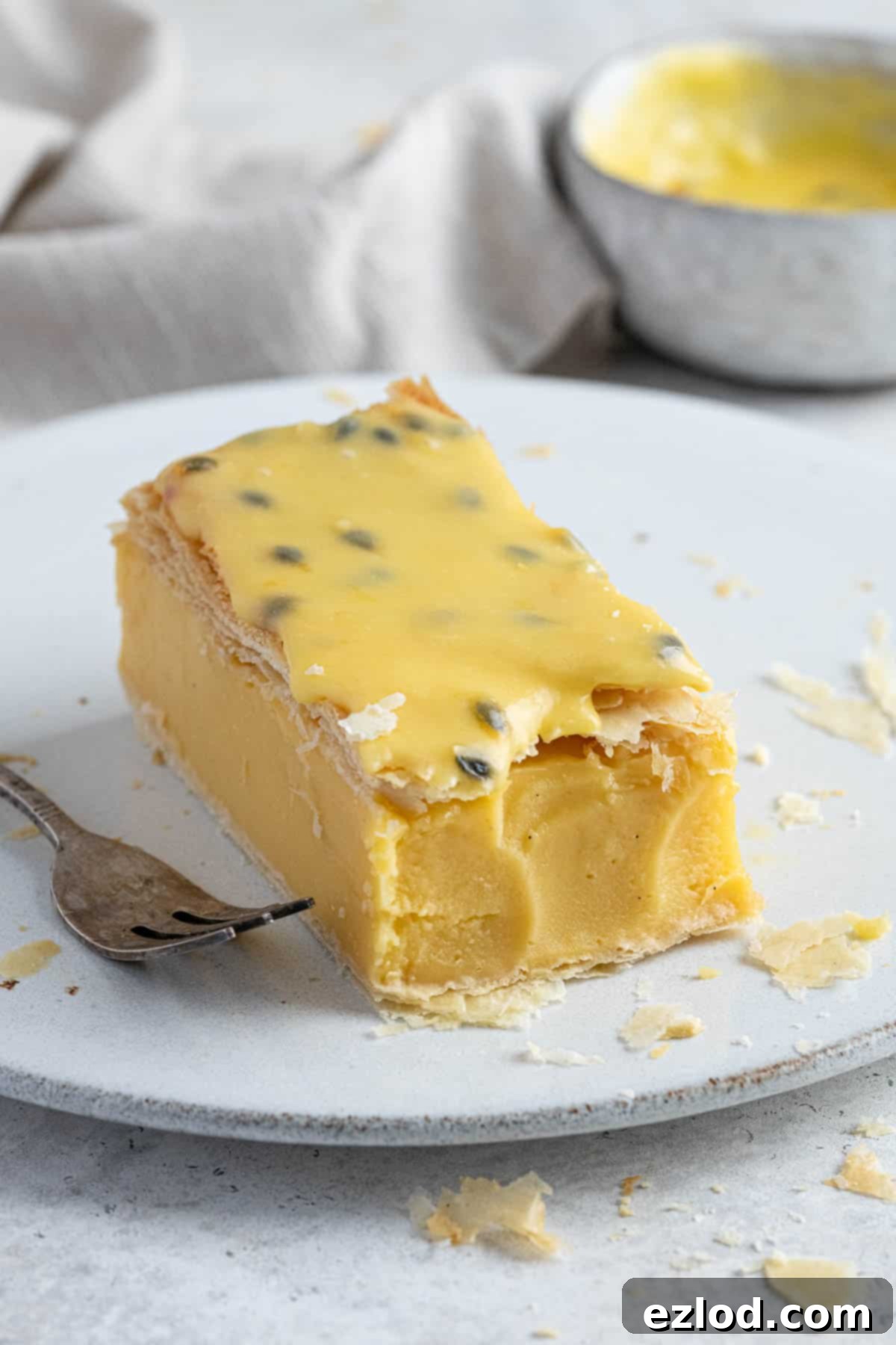 Close up of a vegan vanilla slice with a forkful removed.