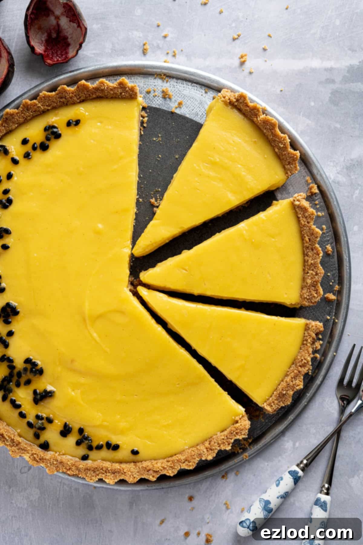 A close-up view of the perfectly sliced vegan passion fruit tart, showcasing its creamy texture.