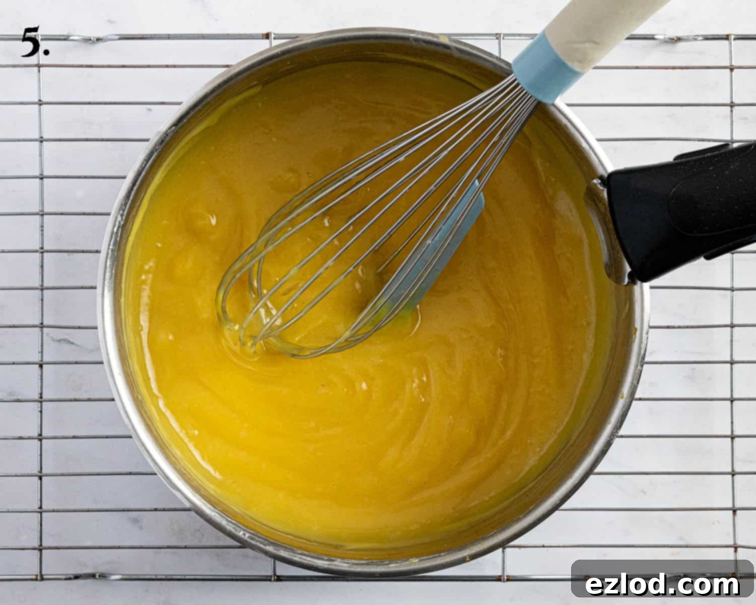 Step 5: The passion fruit tart filling thickened and bubbling gently in a saucepan.