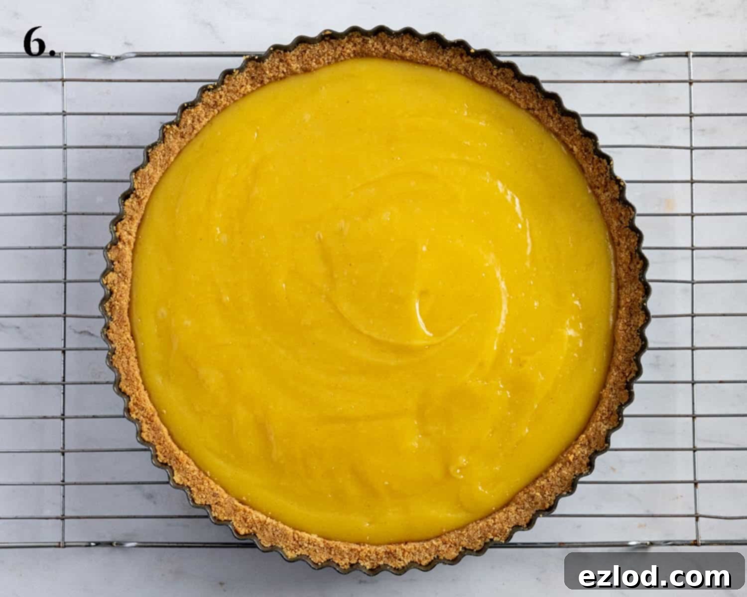 Step 6: The completed vegan passion fruit tart, freshly poured into its biscuit base and ready for chilling.