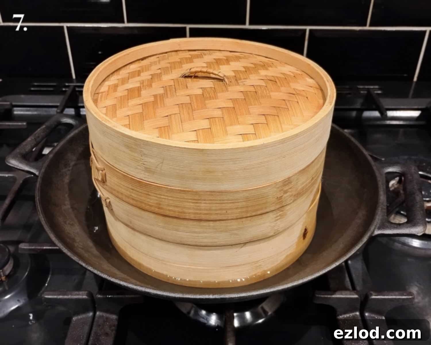 Step 7: The bamboo steamer basket correctly placed in a wok with water.