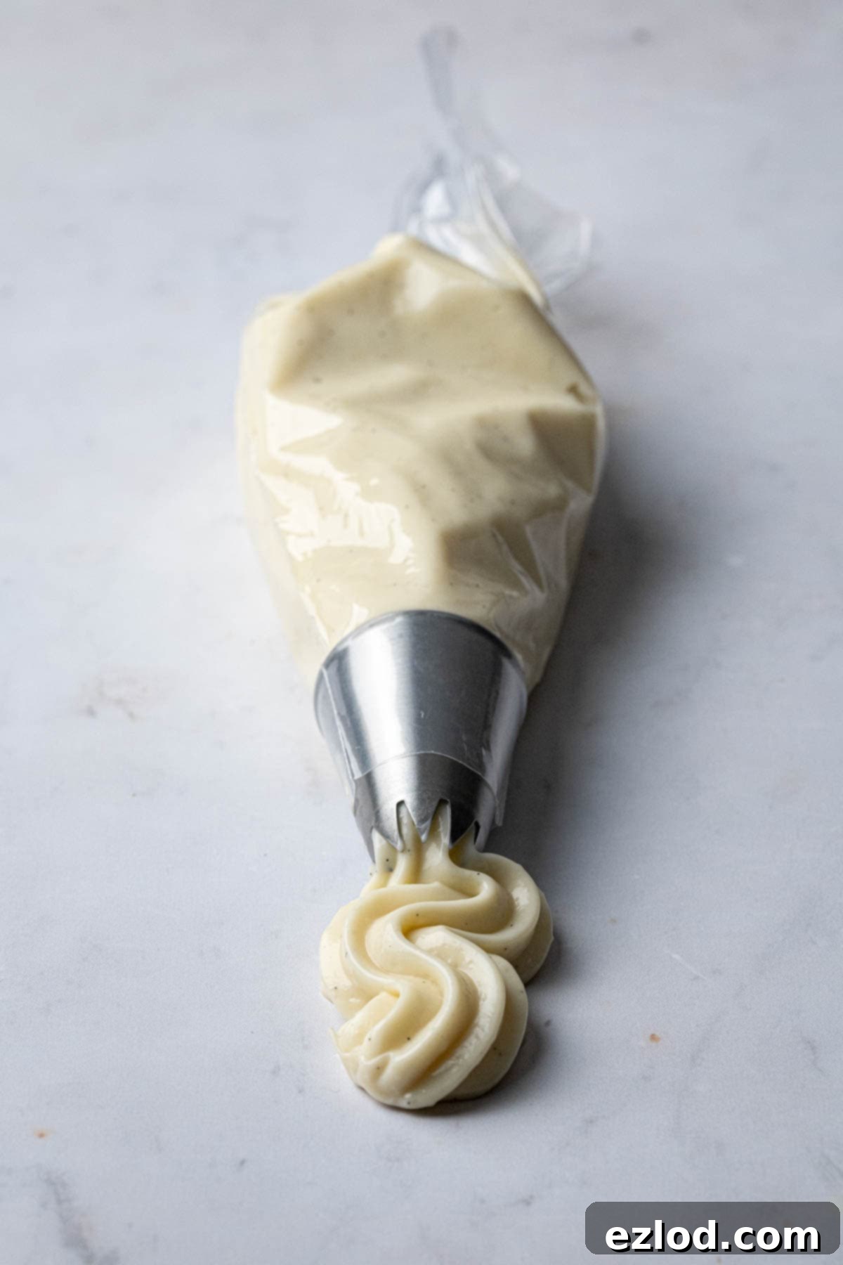 Vegan pastry cream in a piping bag, ready to be used as a filling.