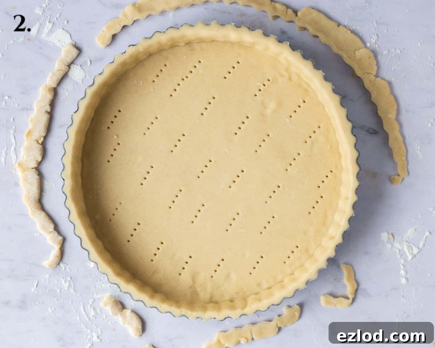 The vegan shortcrust pastry carefully lined and trimmed in a tart tin, ready for freezing.