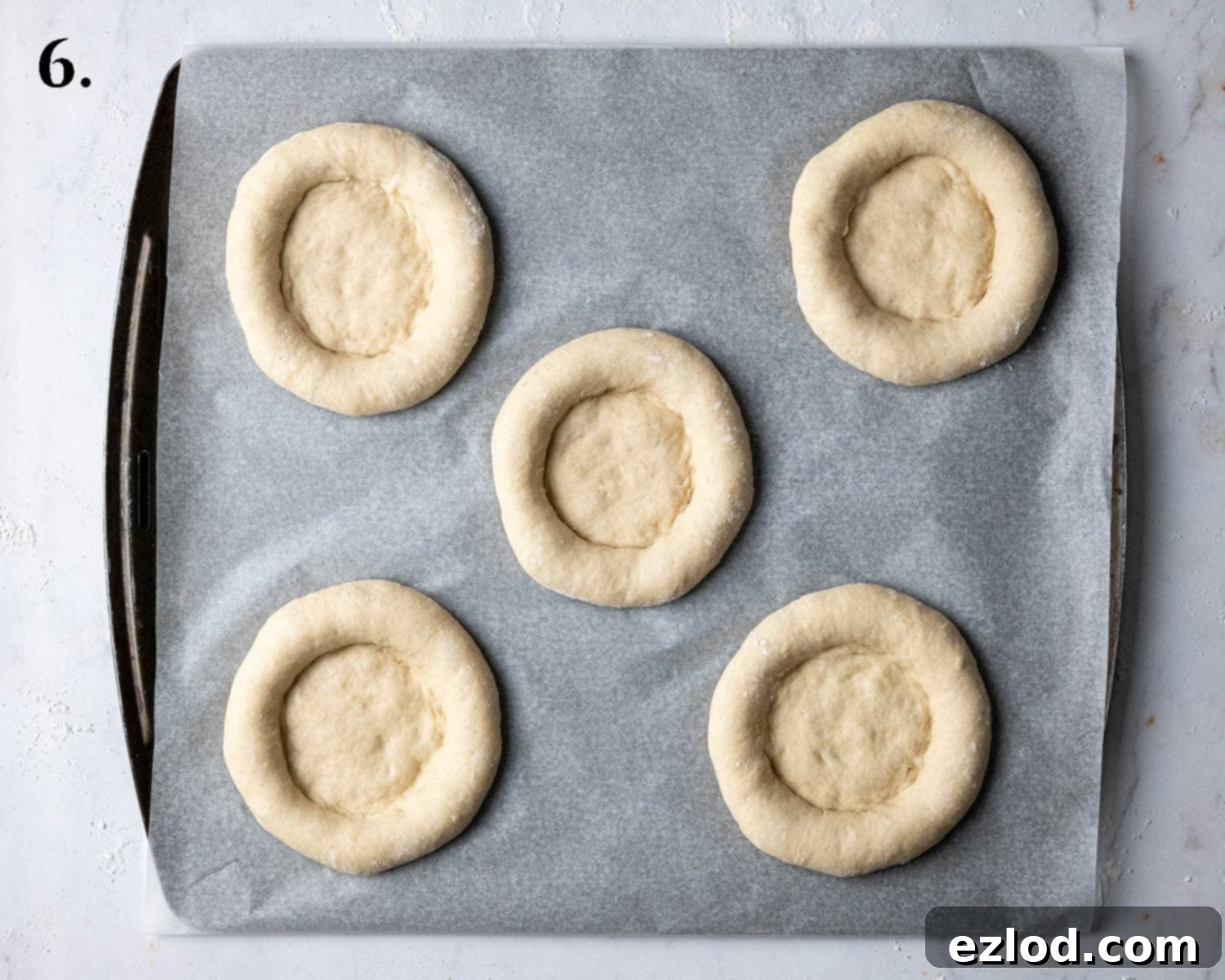 Step 6: The shaped buns after their second rise, looking puffy and expanded on the baking sheet.
