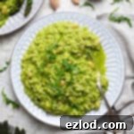 A plate of rocket pesto risotto with asparagus.