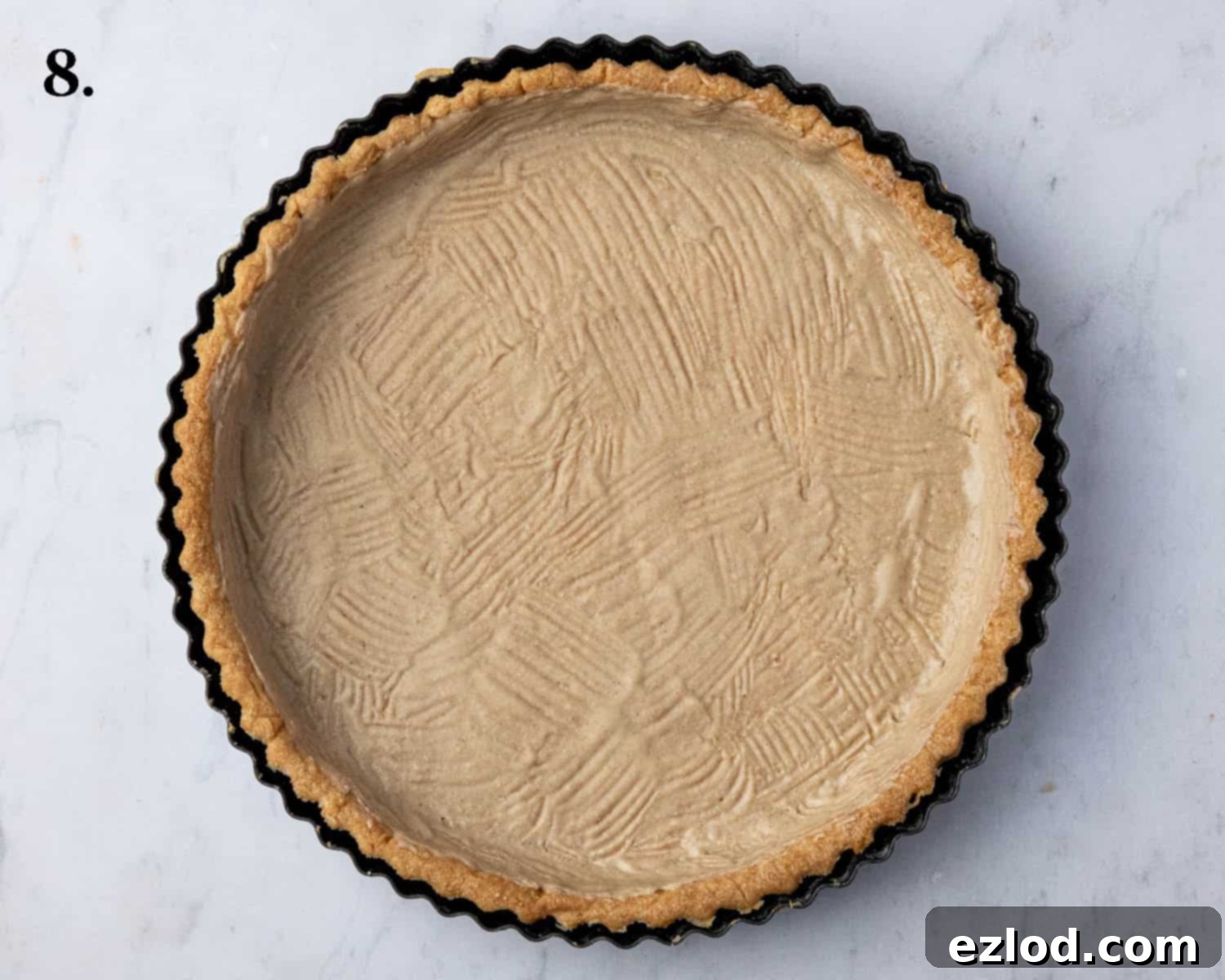 The cooled pastry case with its interior brushed with melted vegan white chocolate, creating a protective layer.