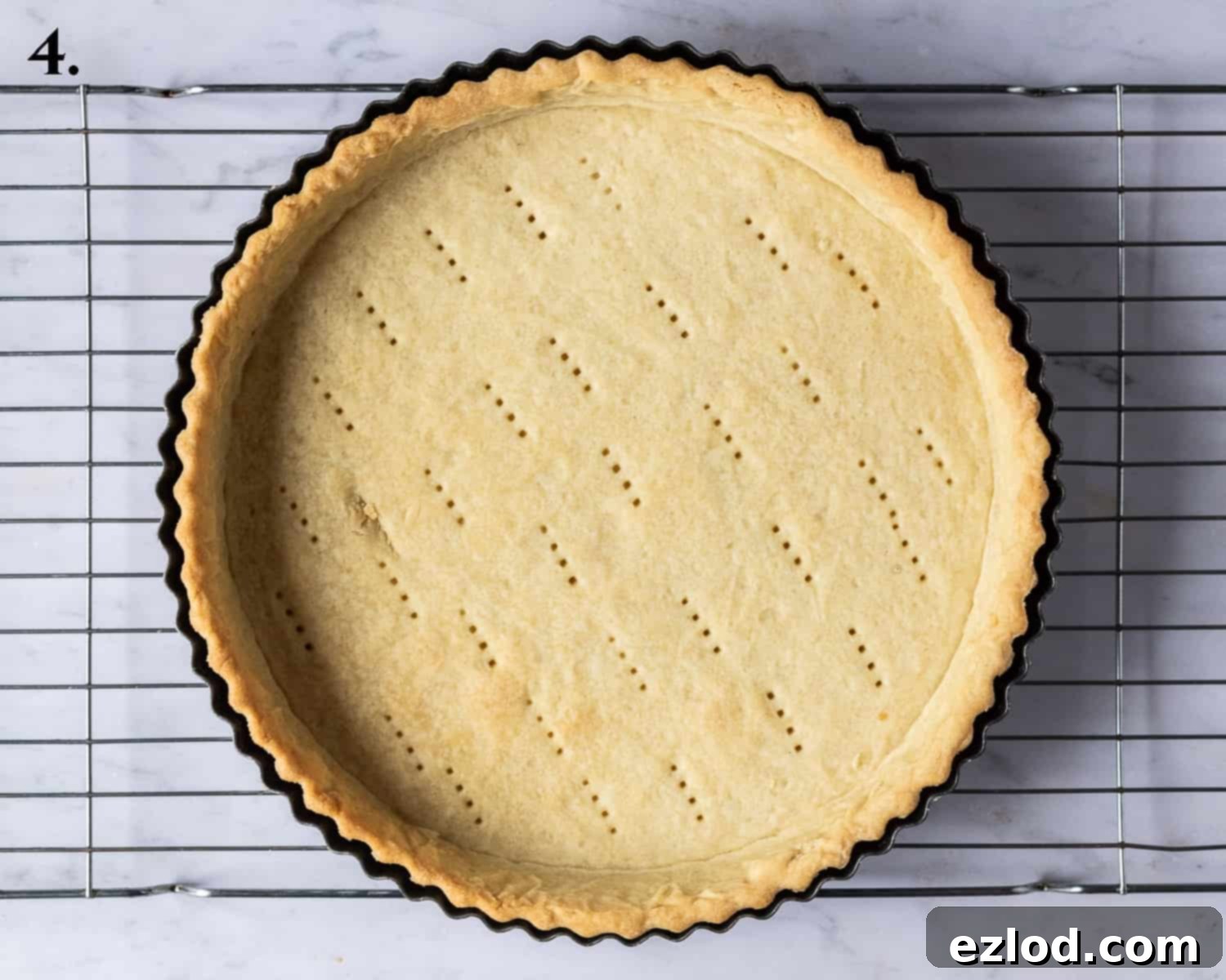 The perfectly blind-baked golden-brown tart shell, removed from the oven and ready for cooling.