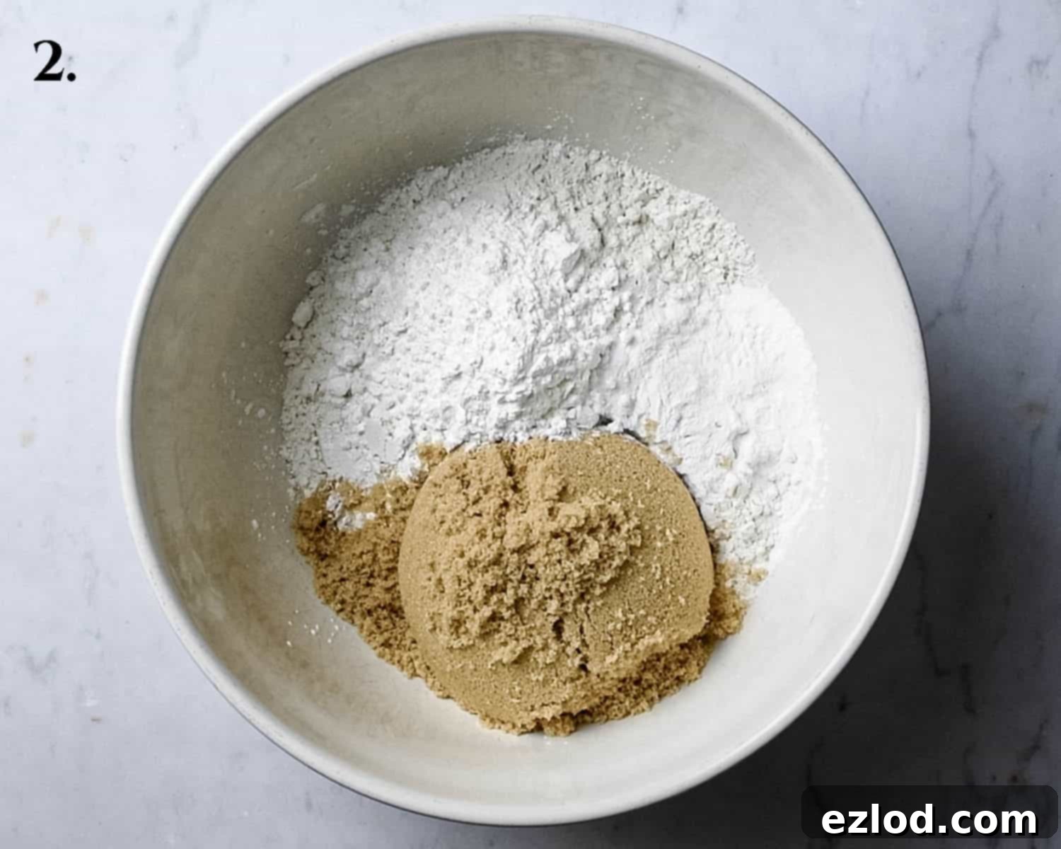 Step 2: A bowl containing all the dry ingredients for the cake batter, perfectly whisked and ready for the wet ingredients.