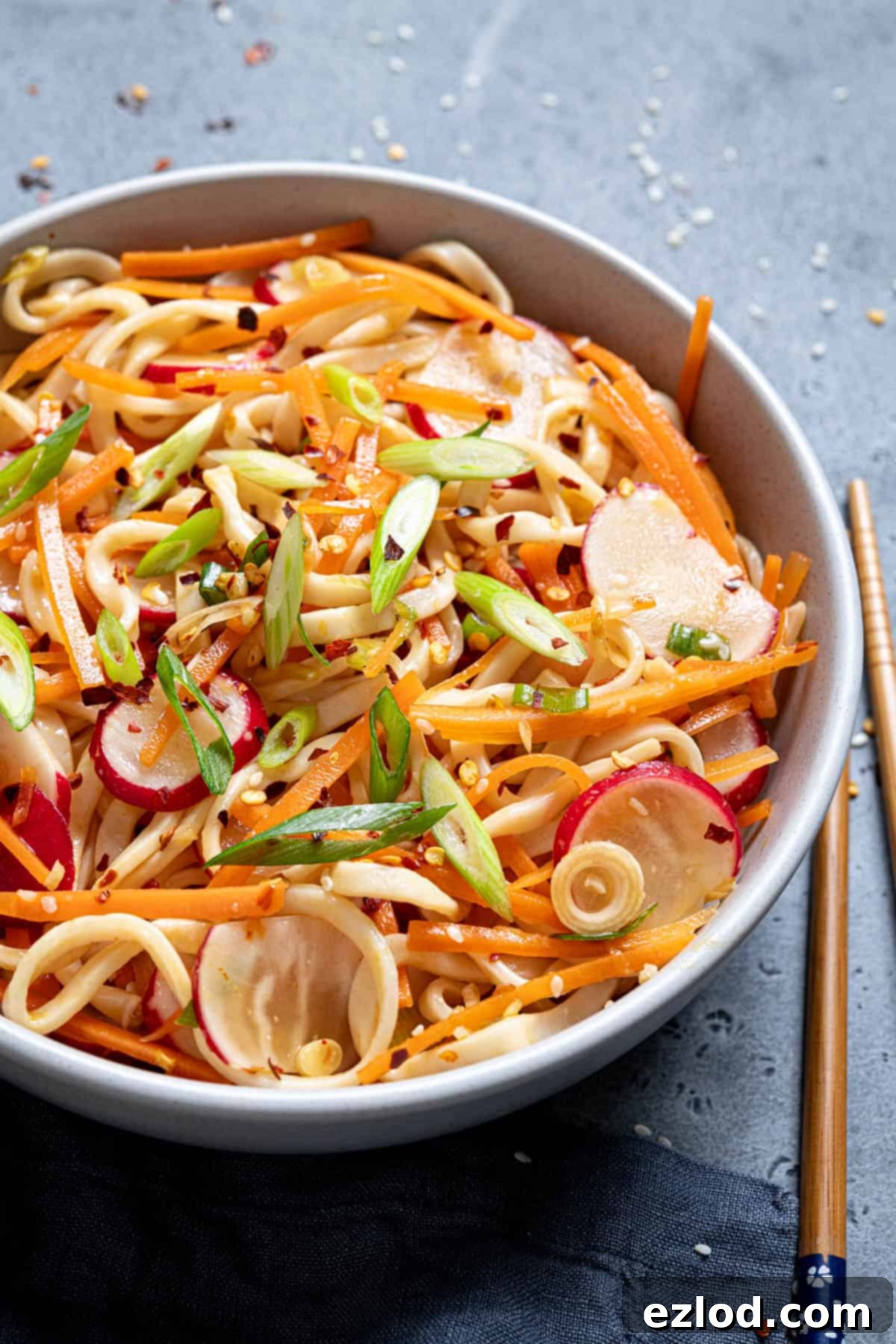 Close up of a bowl of vegetable noodle salad.