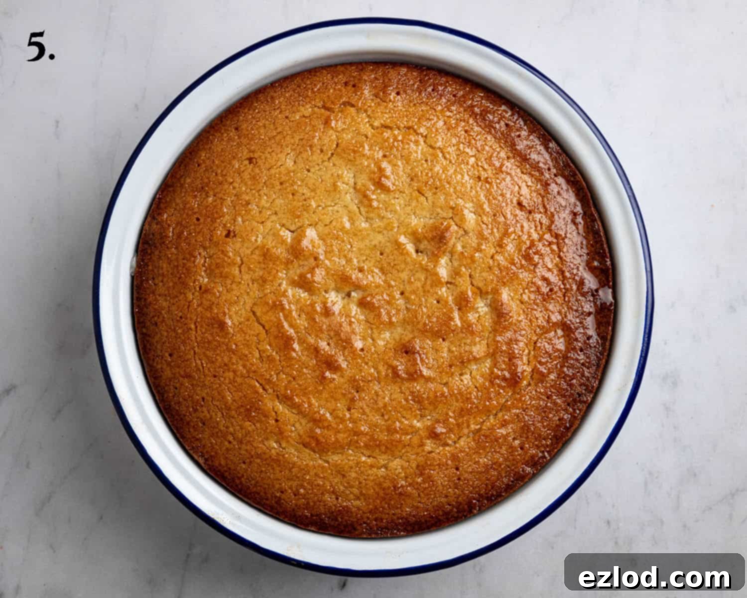 Step 5: The baked lemon elderflower almond pudding with the glossy cordial drizzle poured over its surface, ready to soak in.