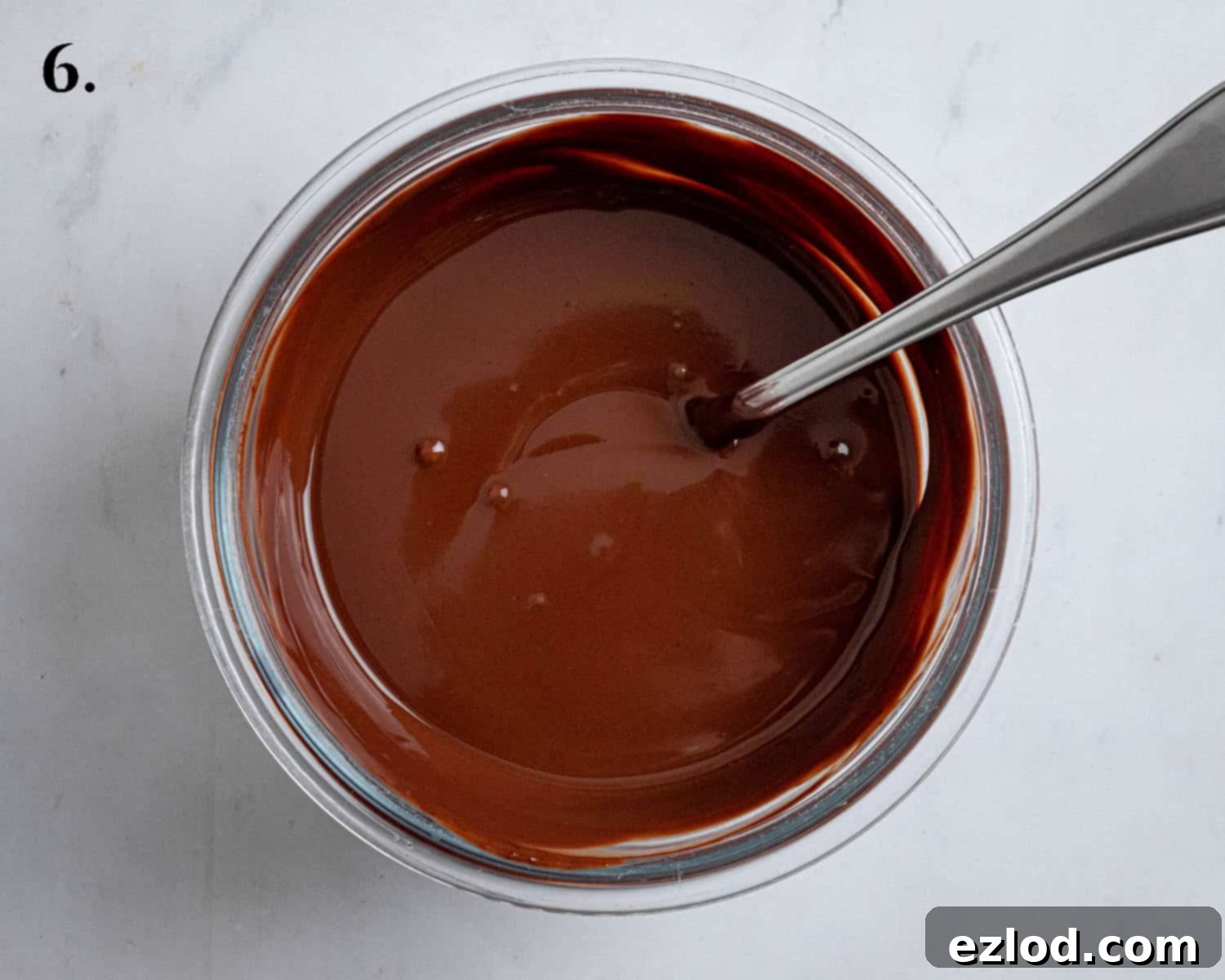 Step 6 of making vegan Boston cream pie: The smooth, rich chocolate ganache resting in a bowl, cooling to the perfect spreading consistency.