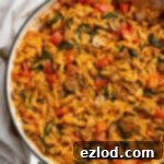 Close up of vegan spicy sausage orzo in a pan.