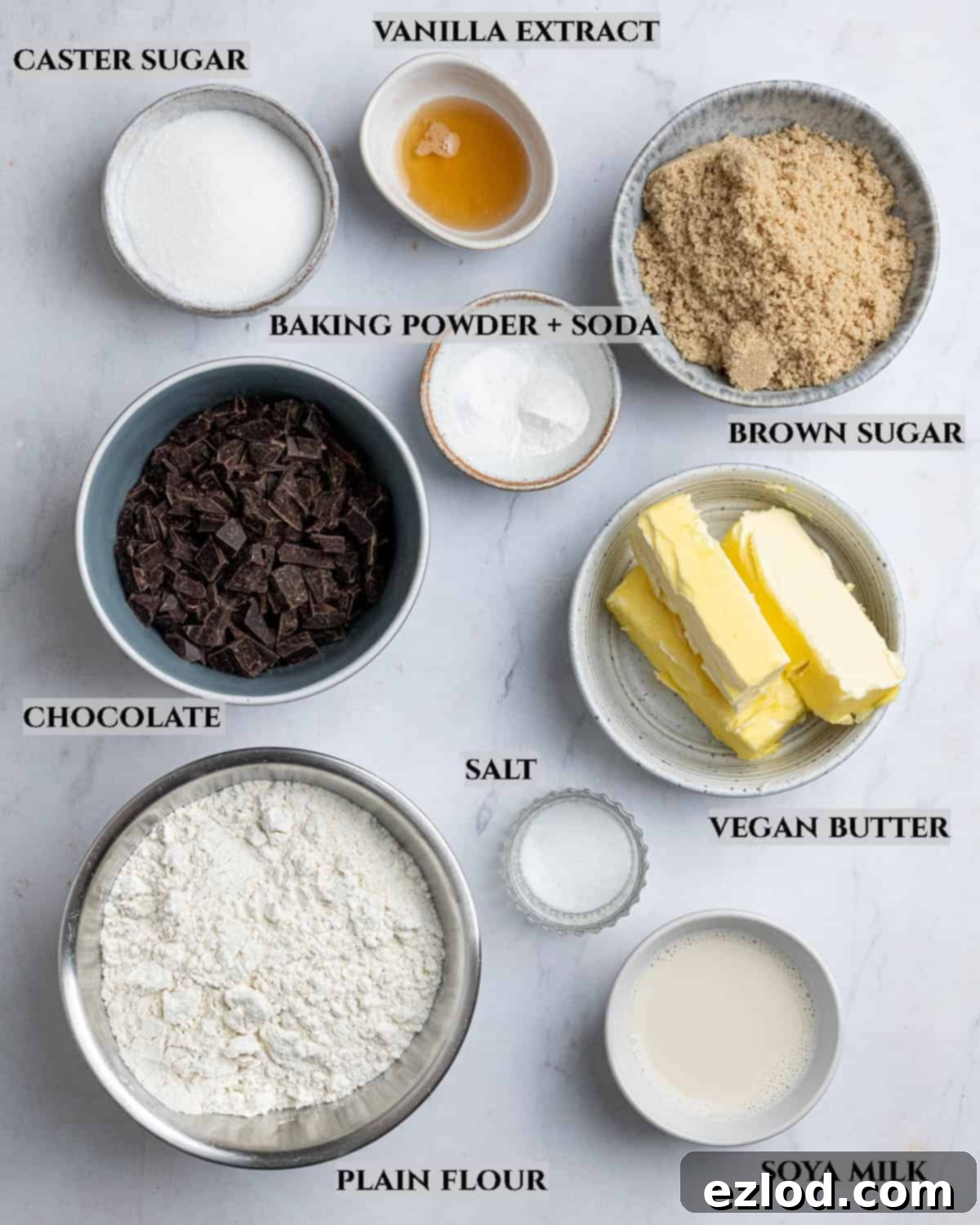 A collection of ingredients laid out, clearly labeled, for making vegan air fryer chocolate chip cookies.
