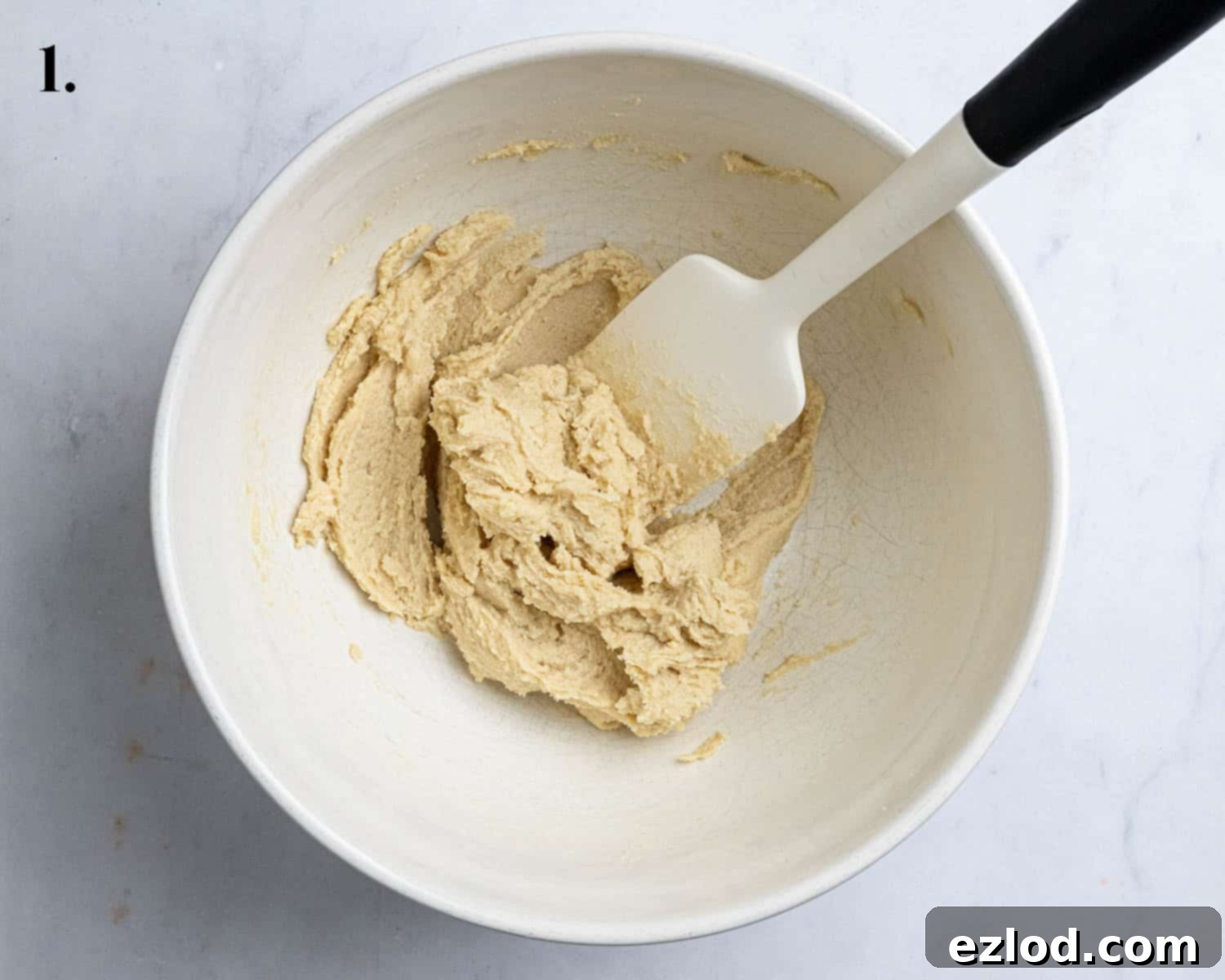 Step 1: Creamed vegan butter and sugars in a mixing bowl, showing a light and fluffy texture.