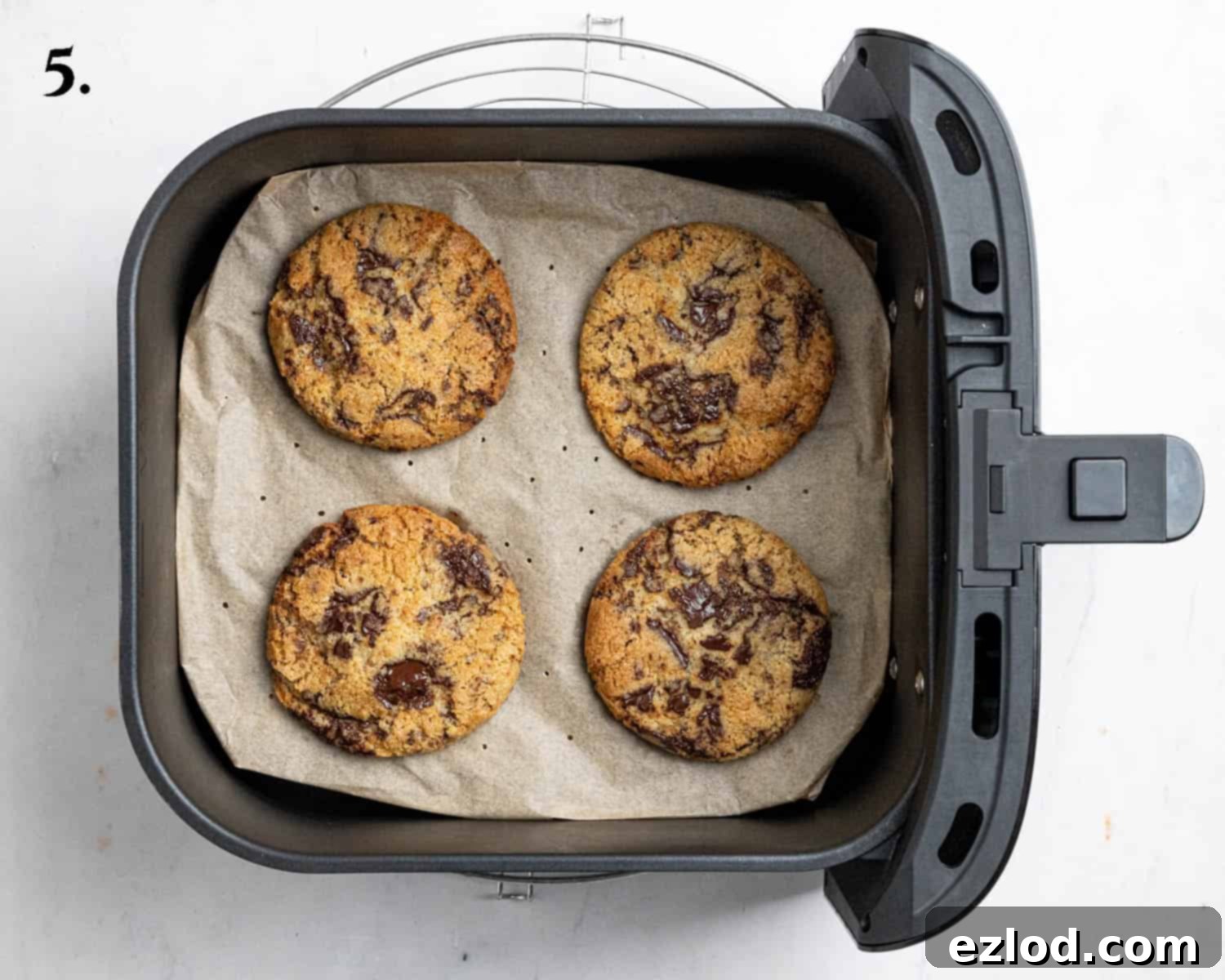 Step 5: Freshly baked vegan air fryer cookies, golden brown at the edges, resting in the air fryer basket.