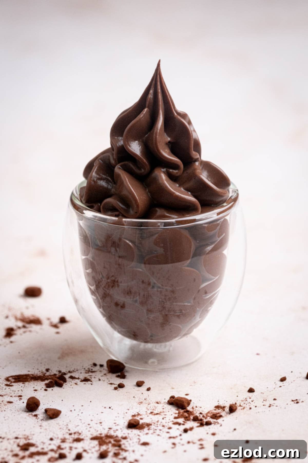 Vegan chocolate pastry cream piped into a small glass.