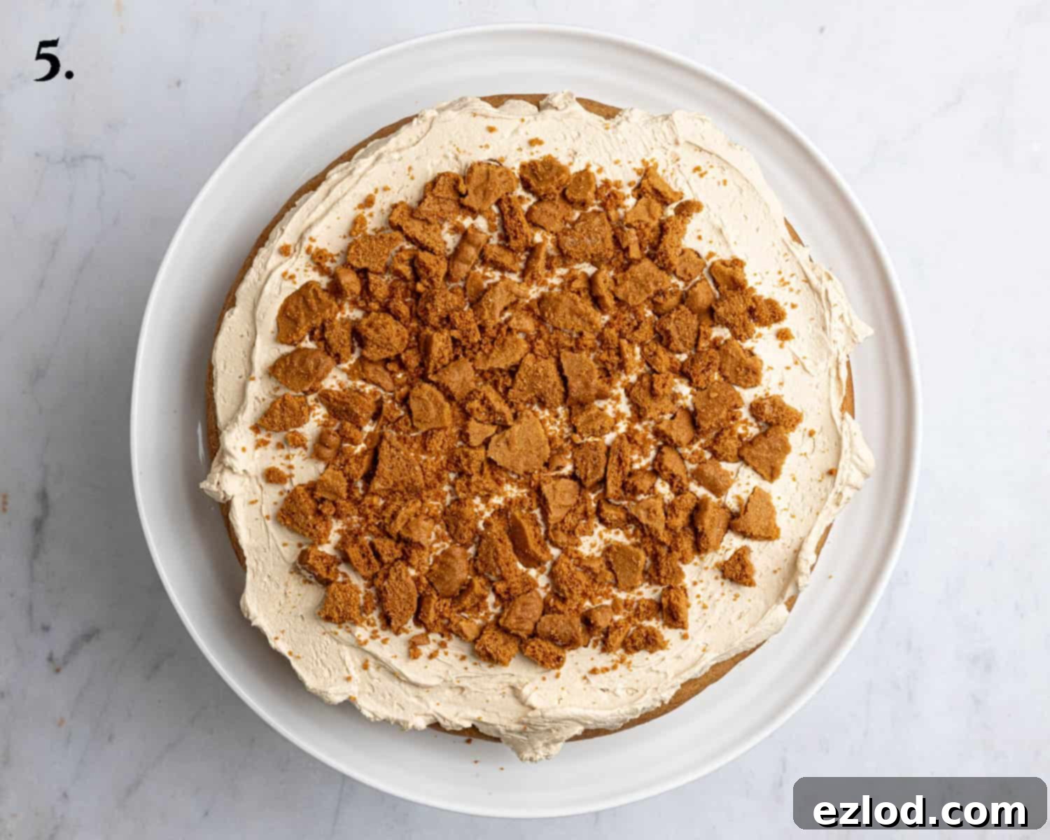 Step 5, one of the cake layers with buttercream and Biscoff cookies.