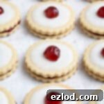 Rows of vegan empire biscuits on a white surface.