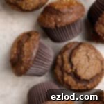 Vegan gingerbread muffins on a brown surface.