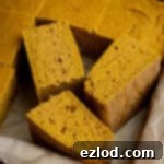 Golden Harvest Vegan Cornbread 11 Squares of vegan pumpkin cornbread in a tin.